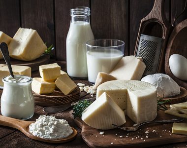 Dairy products assortment shot on rustic wooden table. Dairy products included are milk, yogurt, butter, goat cheese, mozzarella, ricotta, Parmesan cheese, emmental cheese, eggs and hard cheese. Low key DSRL studio photo taken with Canon EOS 5D Mk II and Canon EF 100mm f/2.8L Macro IS USM